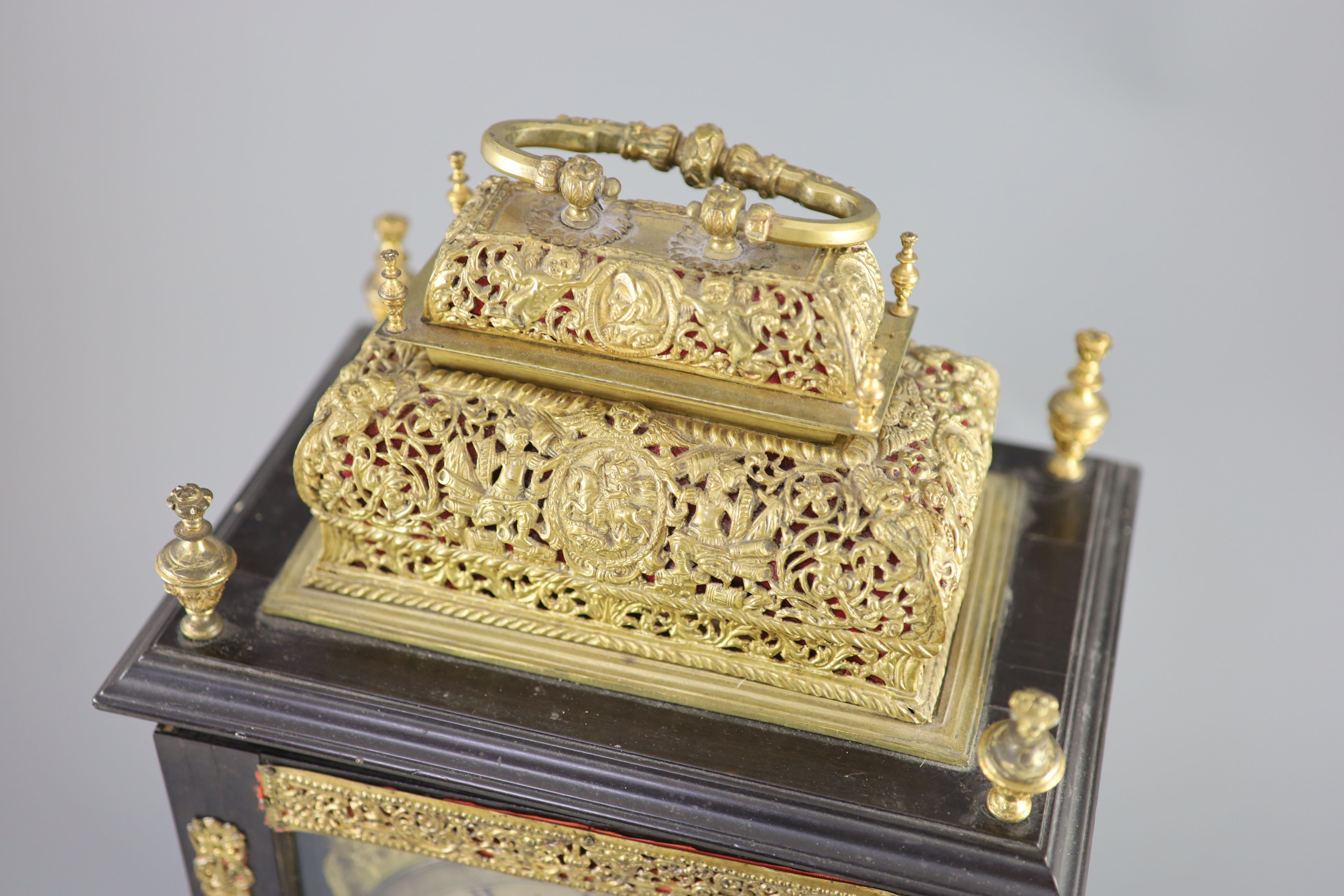 A William III ebonised cased and gilt metal double basket topped chiming and quarter repeating table clock, height 17in.